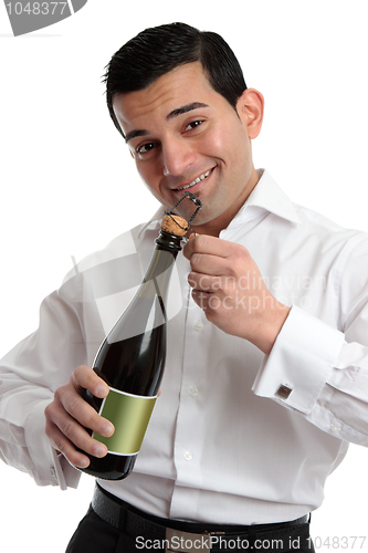 Image of Man or bartender opening wine champagne