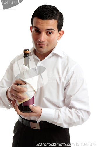 Image of Waiter or servant holding bottle of wine