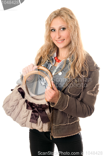 Image of Portrait of smiling young blonde with a handbag