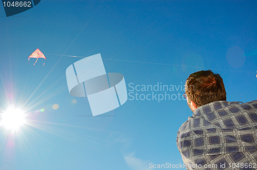 Image of man flying a kite