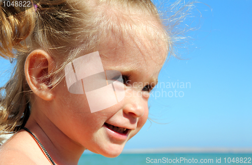 Image of happy little girl on beach