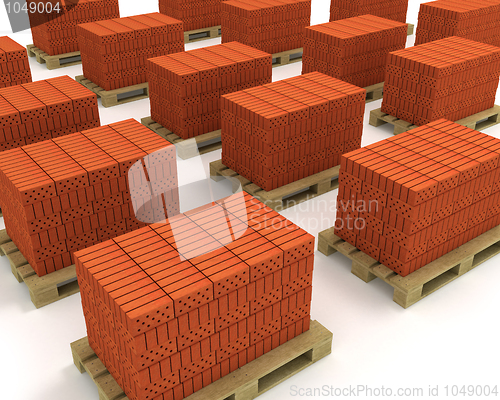 Image of Lot of stacks of orange bricks with pallets isolated