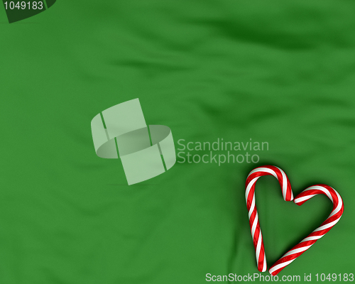 Image of Heart made from christmas candies on green background