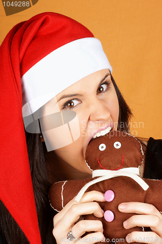 Image of Santa Claus girl with gingerbread man puppet