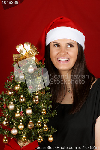 Image of Santa Claus girl with Christmas tree