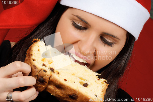 Image of Santa Claus girl eating panettone