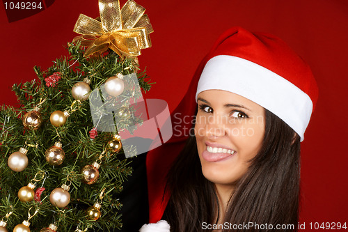 Image of Santa Claus girl with Christmas tree