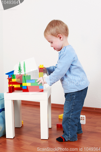 Image of Lovely boy playing with blocks