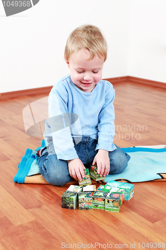 Image of Lovely boy playing with blocks