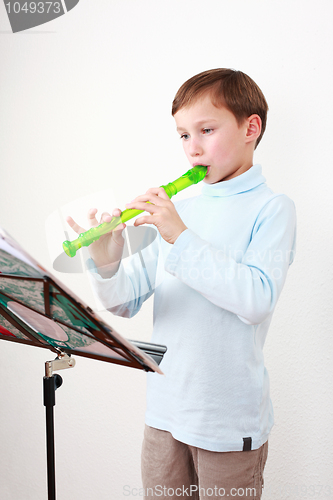 Image of Little boy playing flute