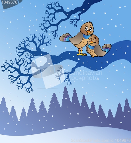 Image of Two cute birds in snowy landscape