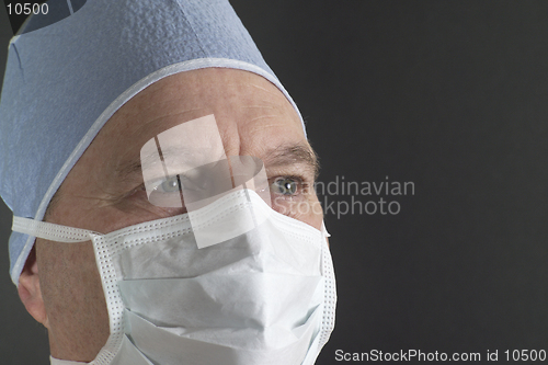 Image of Portrait shot of a male physician in a hat and mask, reflecting confidence, strength, and expertise. Model released. (14MP camera)