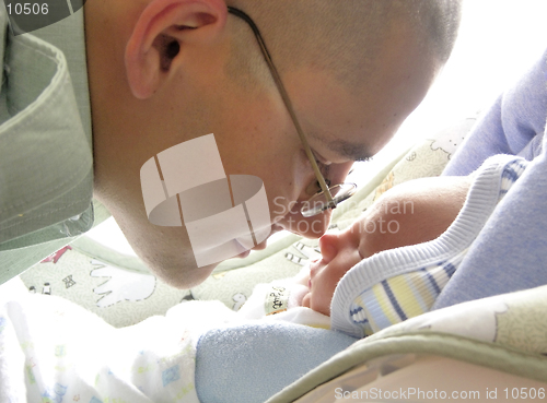 Image of A father soldier meets his newborn son for the first time at 5 days of life.