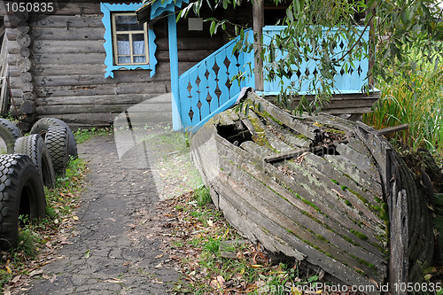 Image of Old Shabby Boat and the House