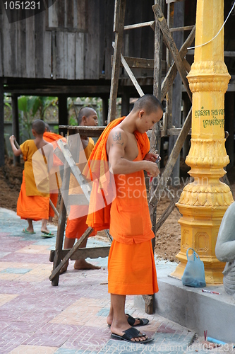 Image of Monks fixing a lamp