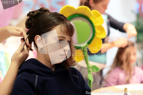 Image of A girl getting her hair done