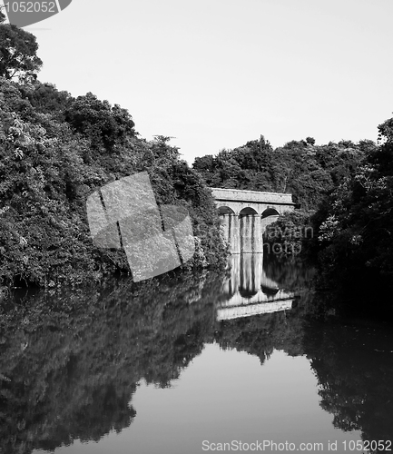 Image of lake with stone bridge, black and white