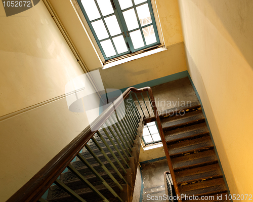 Image of Looking down at an old wooden stairs at an abandoned building