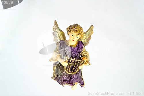 Image of A Christmas ornament of an angel with harp, against a light blue 'sky' background. (14MP camera)