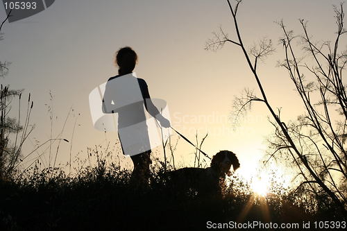 Image of Girl and her dog at sunset