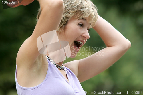 Image of Happy young woman screaming