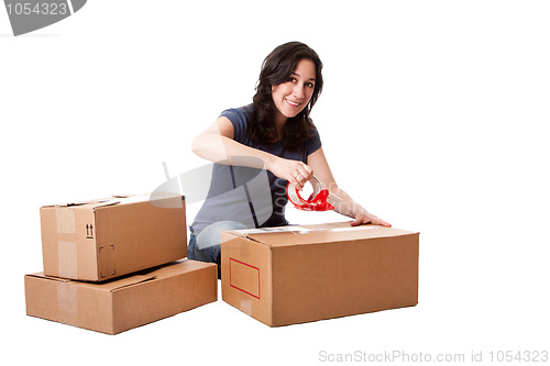 Image of Woman taping moving storage boxes