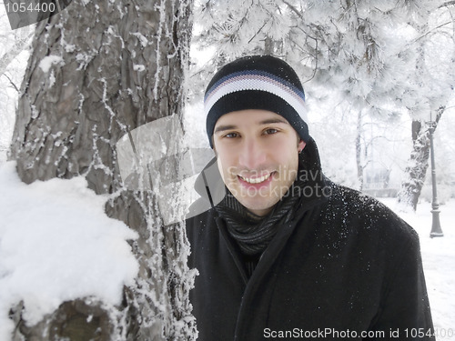 Image of young man smiling in winter park