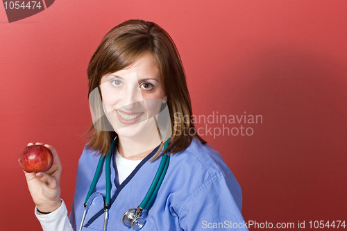 Image of Nurse Holds An Apple