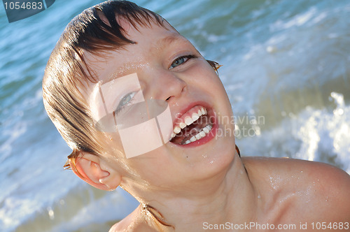 Image of happy boy in waves
