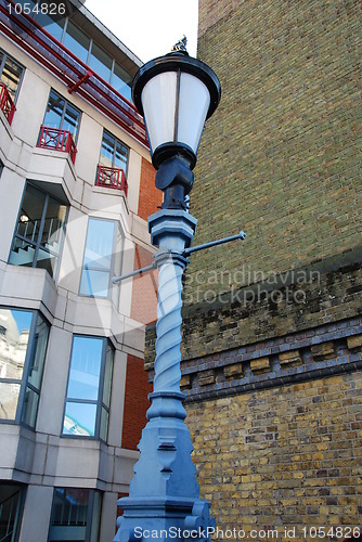 Image of Streetlamp between office building and brick wall