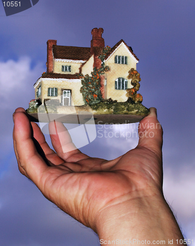 Image of A hand holding a new house