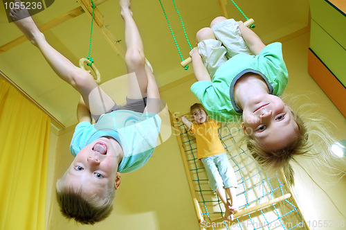 Image of children hanging on gymnastic rings