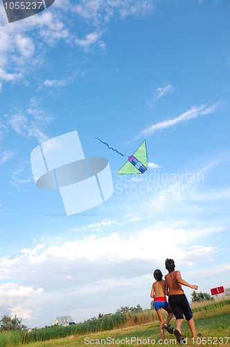 Image of children flying kite in the sky