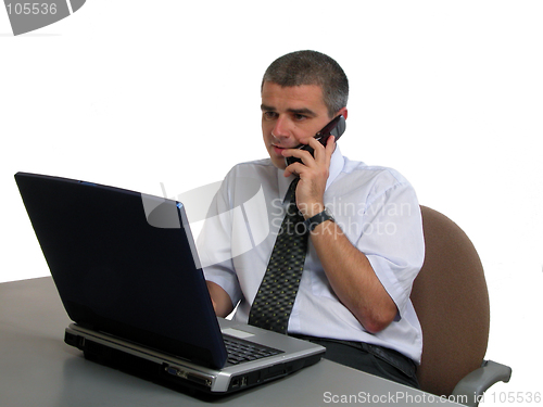 Image of Man speaking to the phone at the office desk