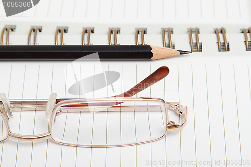 Image of A diary with a pencil and glasses