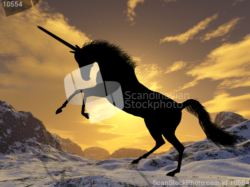 Image of A fantastic unicorn silhouetted against the sunset
