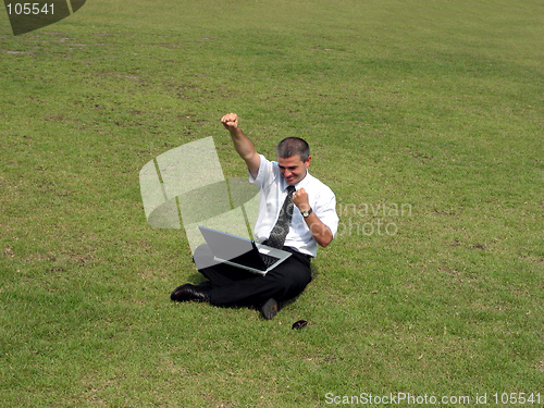 Image of Happy man with computer in the field