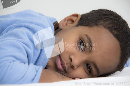 Image of Boy resting in his bed