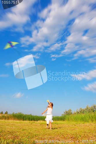 Image of running child flying  a kite