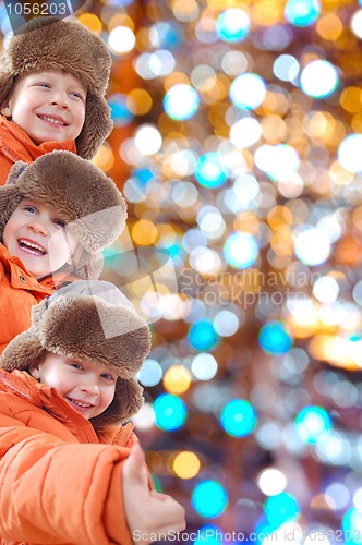 Image of happy winter kids against colorful lights