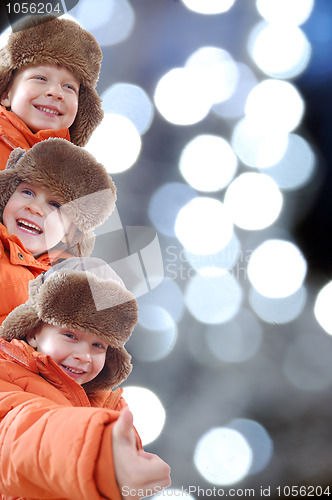 Image of happy winter kids against colorful lights