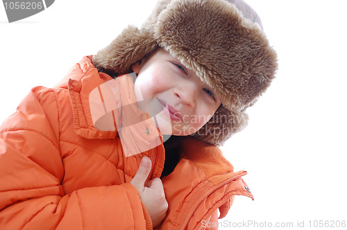 Image of lid wearing a coat and winter fur hat