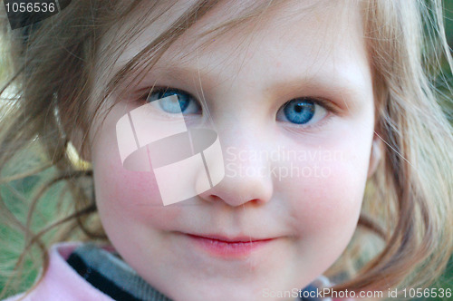 Image of Little girl with rosy cheeks and blue eyes.