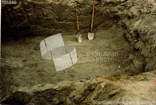 Image of hole with shovels