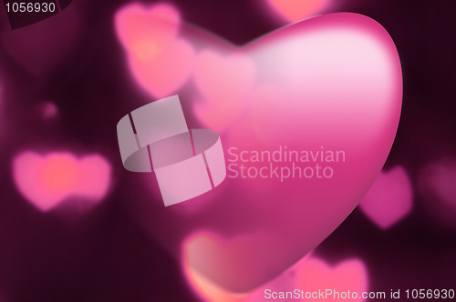 Image of Pink heart fades into out-of-focus heart light background