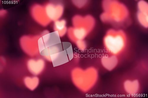 Image of Reddish-pink lights as out-of-focus hearts