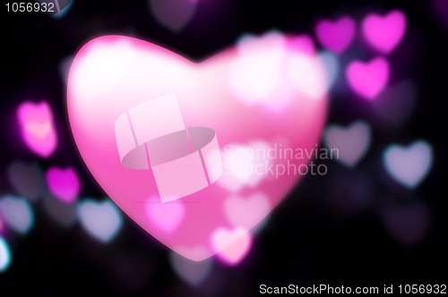 Image of Pink heart blurs into out-of-focus heart-light background