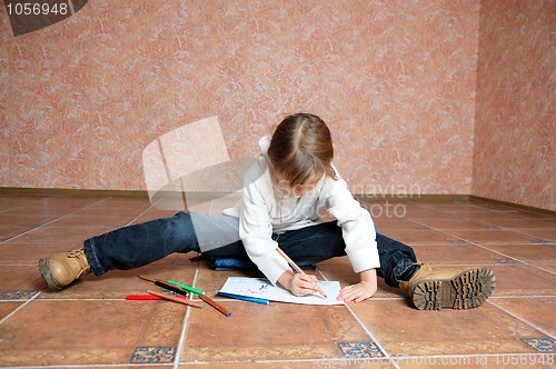 Image of child sitting on the floor and drawing