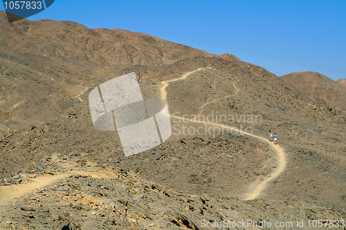 Image of Tourists walking along a mountain path