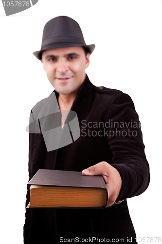Image of happy man standing  offering a book
